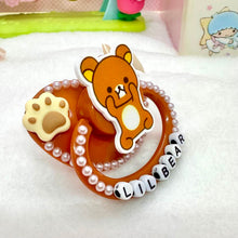 Load image into Gallery viewer, adult deco pacifier paci shop custom decorated binky for age regression store agere ddlg dd lg daddy dom little girl abdl baby diaper lover kawaii littlespace little space rhinestone deluxe kawaii rilakkuma brown bear sanrio paws 
